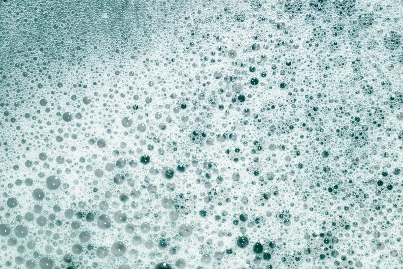 Foam and bubbles covering the surface of water.