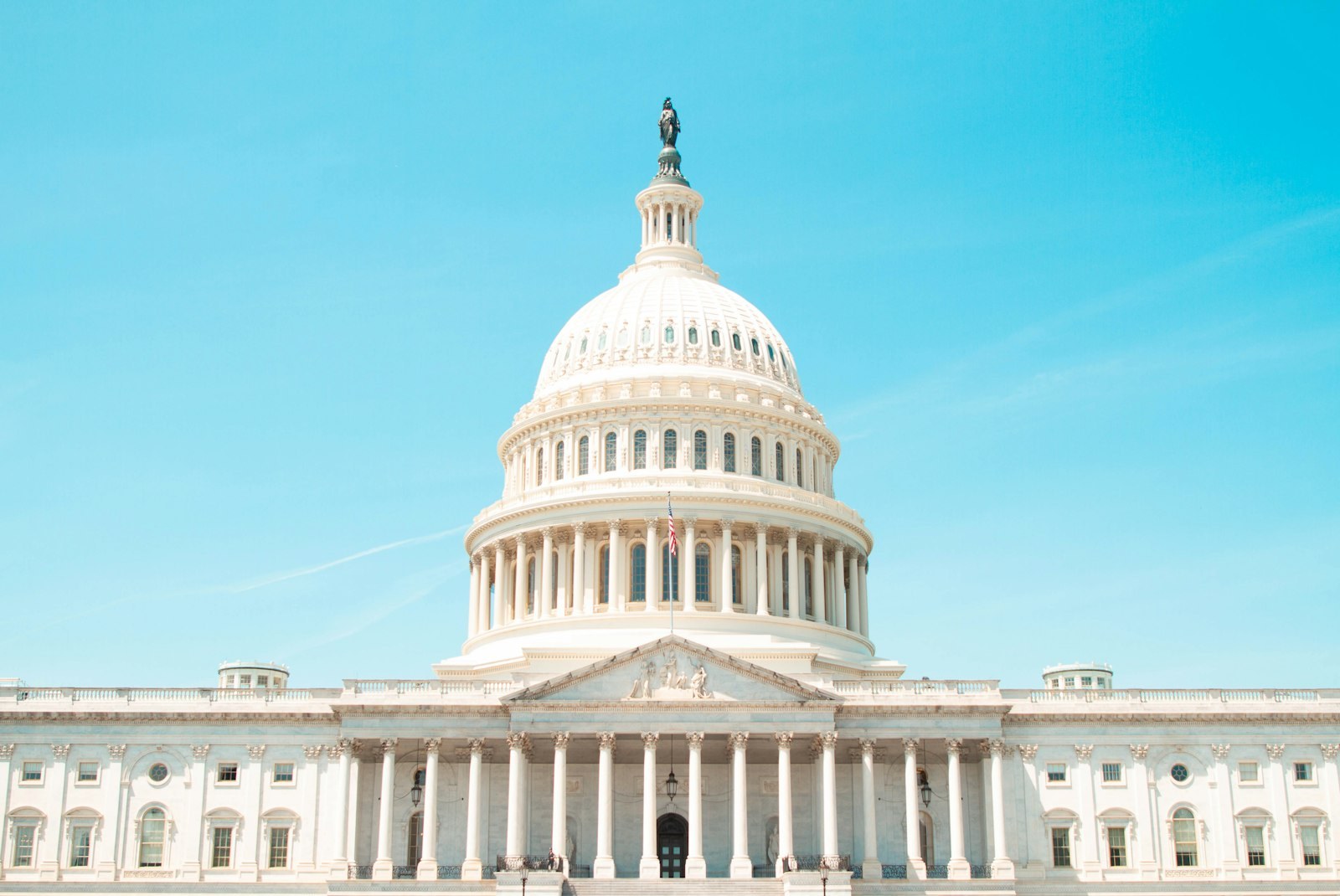The United States Capitol under a clear sky.