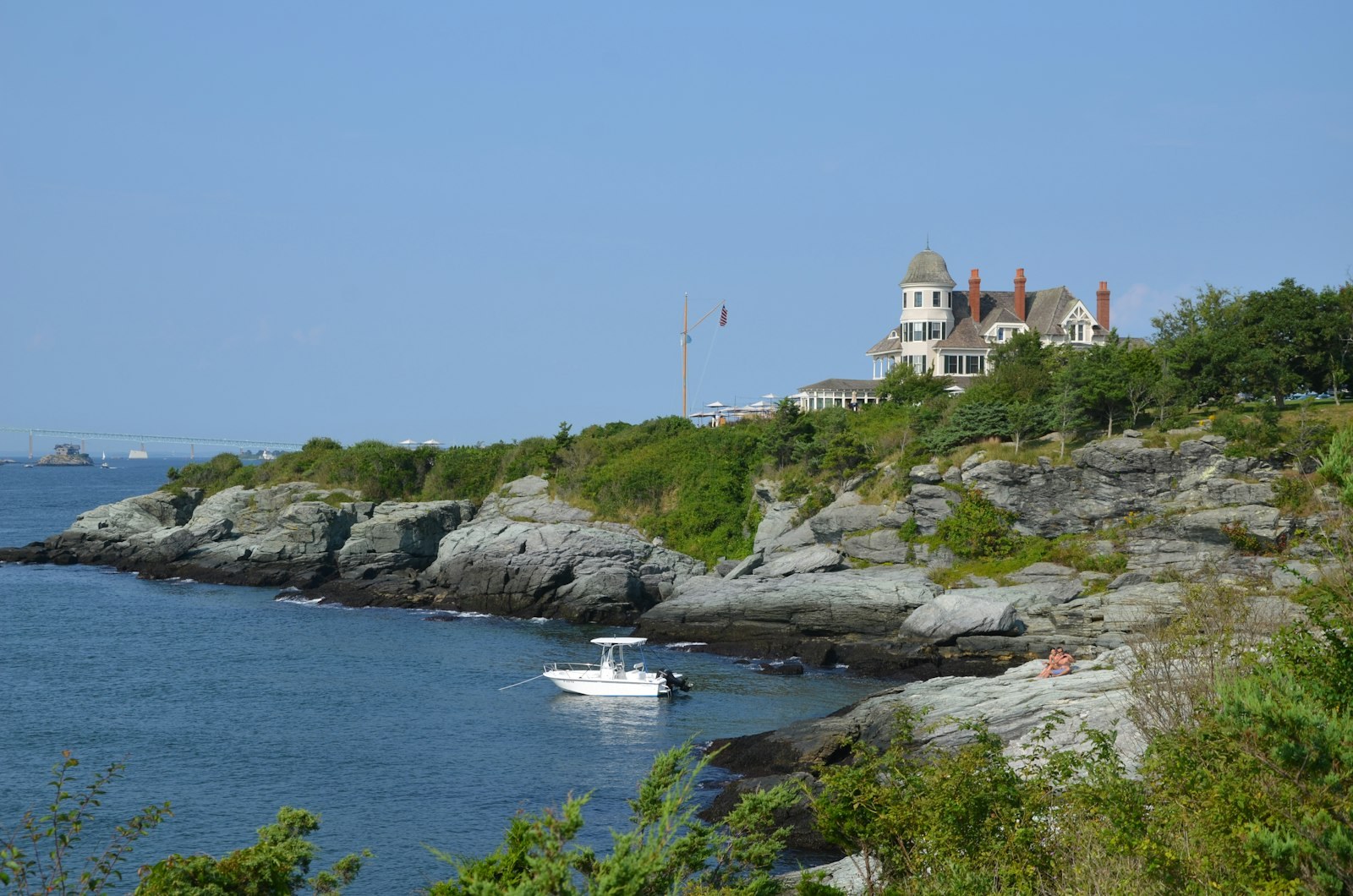 A boat off the rocky shore of Newport, Rhode Island.