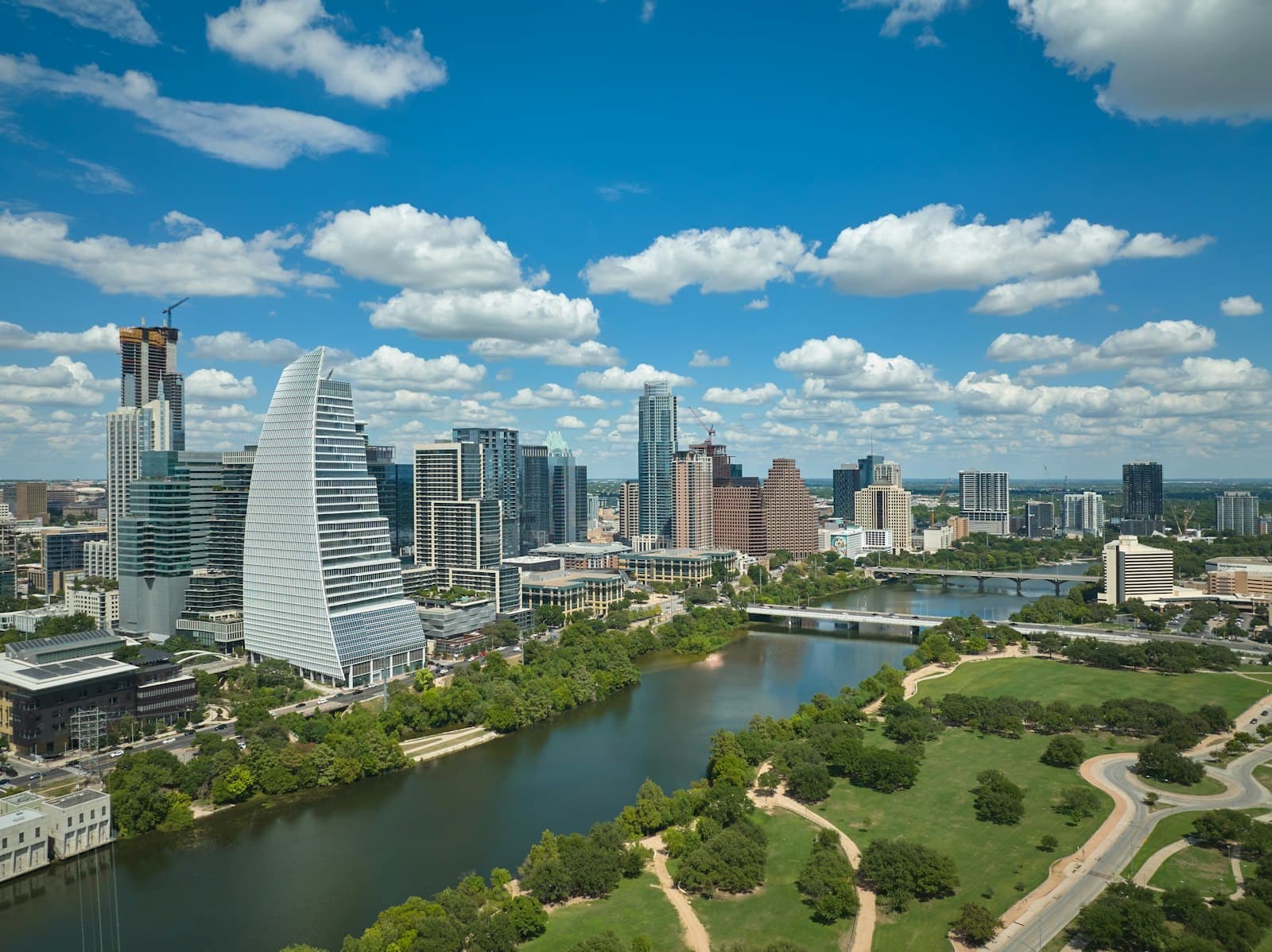 Downtown Austin's towers along Lady Bird Lake on a bright day.